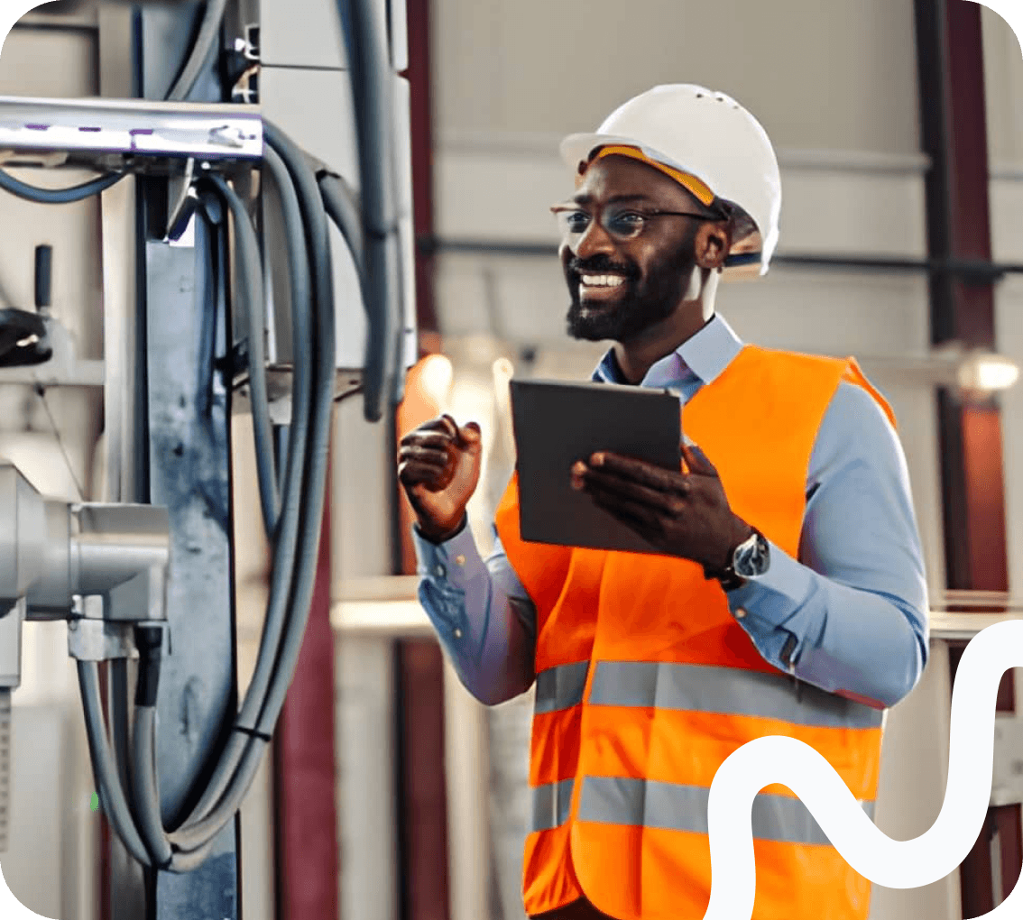 An engineer reviewing a tablet on a production line