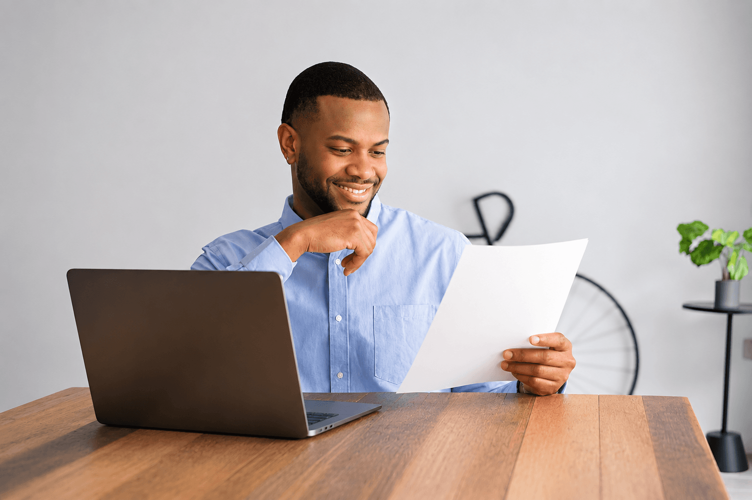 The same business owner smiling while reviewing a document